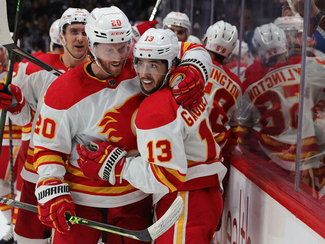 DENVER, COLORADO - MARCH 05: Johnny Gaudreau #13 of the Calgary Flames celebrates a game winning goal against the Colorado Avalanche with teammate Blake Coleman #20 at Ball Arena on March 05, 2022 in Denver, Colorado. The Flames defeated the Avalanche 4-3 in overtime.