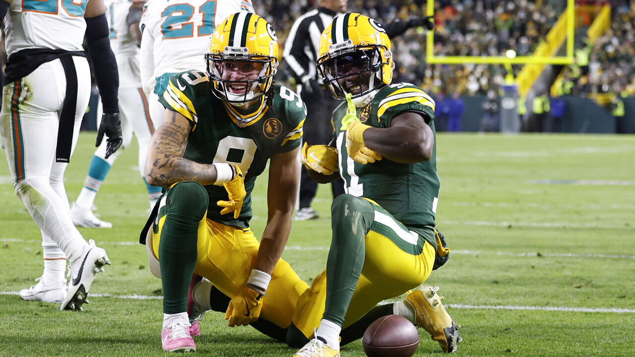 GREEN BAY, WISCONSIN - NOVEMBER 28: Jayden Reed #11 of the Green Bay Packers celebrates with teammate Christian Watson #9 after scoring a touchdown against the Miami Dolphins during the second quarter of the game at Lambeau Field on November 28, 2024 in Green Bay, Wisconsin.