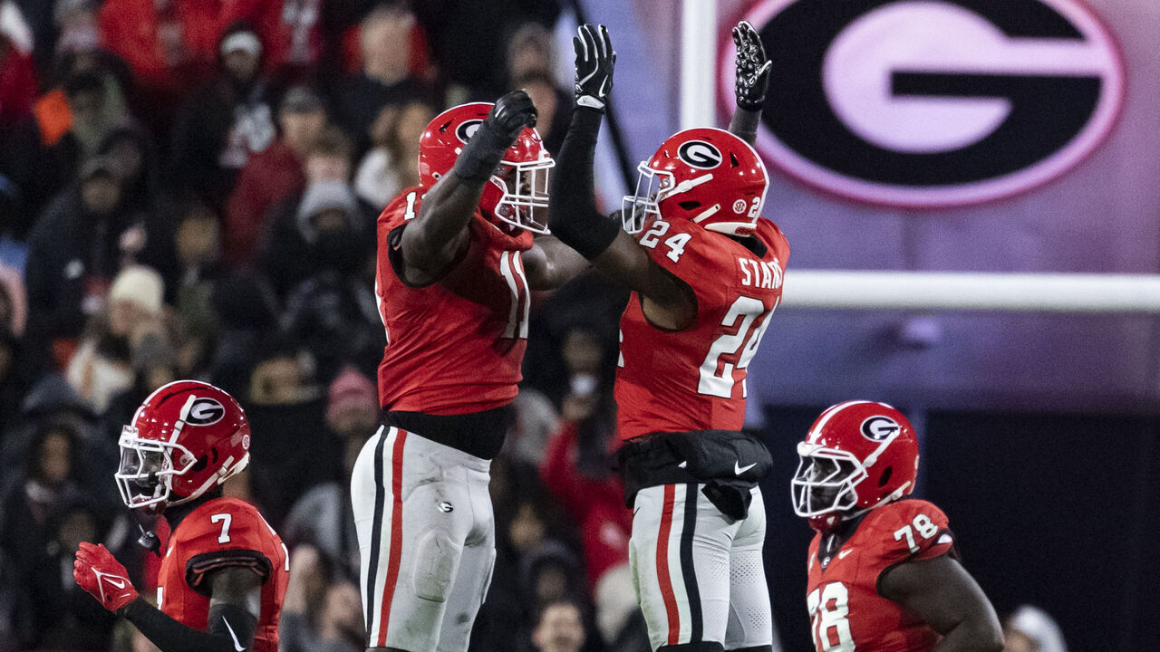 ATHENS, GEORGIA - NOVEMBER 29: Jalon Walker #11 and Malaki Starks #24 of the Georgia Bulldogs celebrate a big stop during a game between the Georgia Tech Yellow Jackets and the Georgia Bulldogs at Sanford Stadium on November 29, 2024 in Athens, Georgia.
