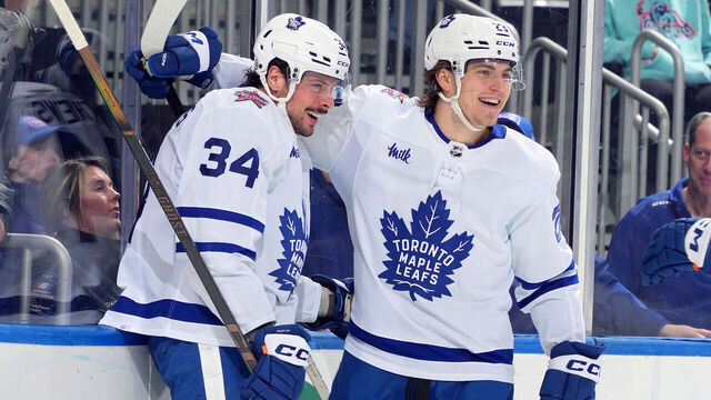ELMONT, NEW YORK - JANUARY 11: Auston Matthews #34 of the Toronto Maple Leafs is congratulated by Matthew Knies #23 after scoring a goal against the New York Islanders during the second period at UBS Arena on January 11, 2024 in Elmont, New York.