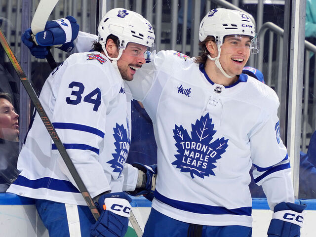 ELMONT, NEW YORK - JANUARY 11: Auston Matthews #34 of the Toronto Maple Leafs is congratulated by Matthew Knies #23 after scoring a goal against the New York Islanders during the second period at UBS Arena on January 11, 2024 in Elmont, New York.