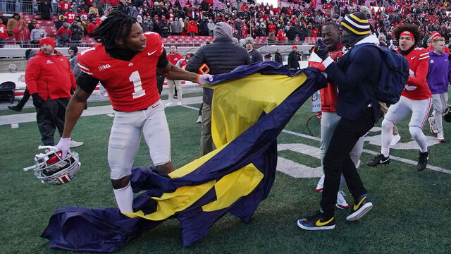 COLUMBUS, OHIO - NOVEMBER 30: Davison Igbinosun #1 of the Ohio State Buckeyes grabs a Michigan flag following his team's defeat against the Michigan Wolverines at Ohio Stadium on November 30, 2024 in Columbus, Ohio.