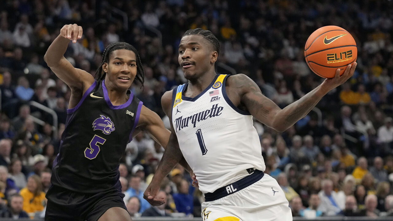 MILWAUKEE, WISCONSIN - NOVEMBER 30: Kam Jones #1 of the Marquette Golden Eagles goes to the basket against Brandon Morgan #5 of the Western Carolina Catamounts during the first half at Fiserv Forum on November 30, 2024 in Milwaukee, Wisconsin.