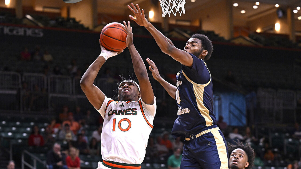 CORAL GABLES, FL - NOVEMBER 30: Miami guard Paul Djobet (10) puts up a basket while defended by Charleston Southern forward Jaylon Gibson (8) in the second half as the Miami Hurricanes faced the Charleston Southern Buccaneers on November 30, 2024, at the Watsco Center in Coral Gables, Florida.