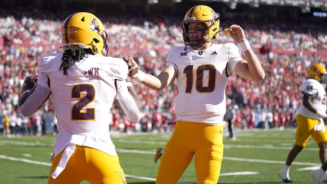 TUCSON, ARIZONA - NOVEMBER 30: Sam Leavitt #10 of Arizona State celebrates with teammate Kyson Brown #2 after a touchdown in the second quarter against the University of Arizona at Arizona Stadium on November 30, 2024, in Tucson, Arizona.