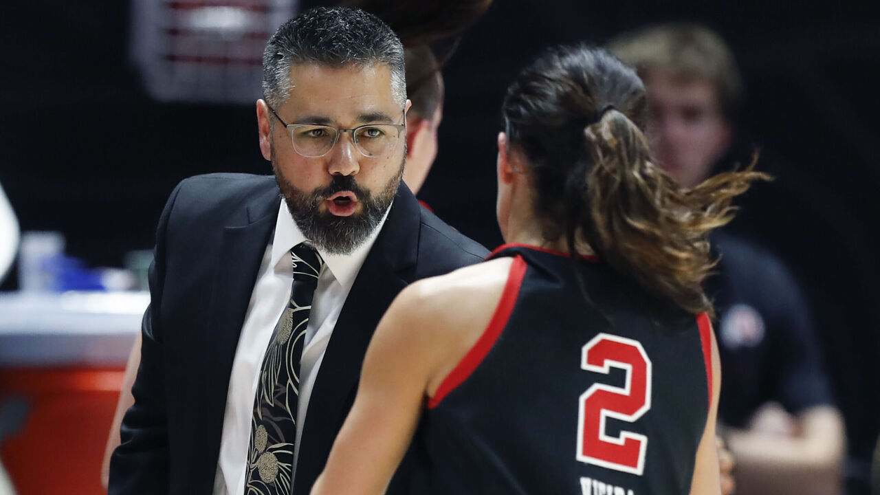 SALT LAKE CITY , UT - NOVEMBER 22: Gavin Petersen head coach of the Utah Utes congratulates Ines Vieira #2 as she comes off the court during the first half of their game agianst the St. Joseph's Hawks at the Jon M Huntsman Center on November 22, 2024 in Salt Lake City, Utah.