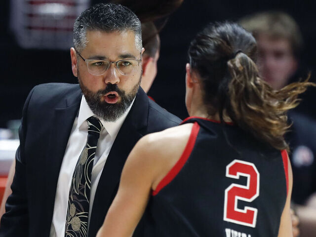SALT LAKE CITY , UT - NOVEMBER 22: Gavin Petersen head coach of the Utah Utes congratulates Ines Vieira #2 as she comes off the court during the first half of their game agianst the St. Joseph's Hawks at the Jon M Huntsman Center on November 22, 2024 in Salt Lake City, Utah.