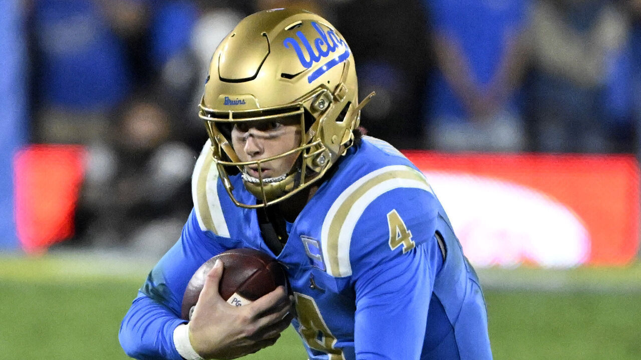 Pasadena, CA - November 23: Quarterback Ethan Garbers #4 of the UCLA Bruins slides for the first down against the USC Trojans in the first half of a NCAA Football game at the Rose Bowl in Pasadena on Saturday, November 23, 2024.