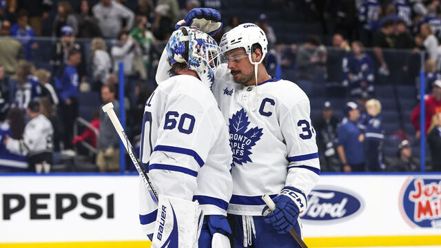 TAMPA, FL - NOVEMBER 30: Goalie Joseph Woll #60 of the Toronto Maple Leafs celebrates a win against the Tampa Bay Lightning with teammate Auston Matthews #34 at Amalie Arena on November 30, 2024 in Tampa, Florida.