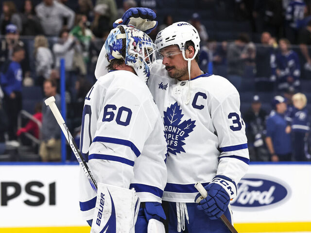 TAMPA, FL - NOVEMBER 30: Goalie Joseph Woll #60 of the Toronto Maple Leafs celebrates a win against the Tampa Bay Lightning with teammate Auston Matthews #34 at Amalie Arena on November 30, 2024 in Tampa, Florida.
