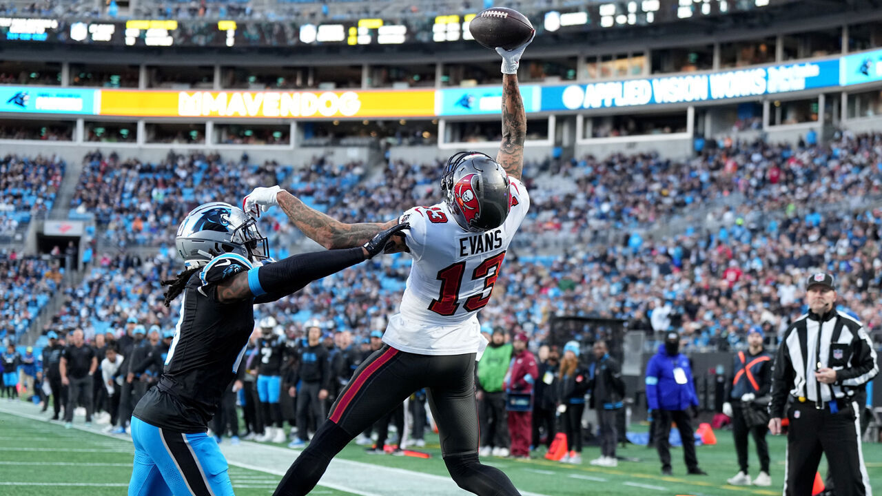 CHARLOTTE, NORTH CAROLINA - DECEMBER 01: Mike Evans #13 of the Tampa Bay Buccaneers catches a pass in front of Jaycee Horn #8 of the Carolina Panthers for a first quarter touchdown at Bank of America Stadium on December 01, 2024 in Charlotte, North Carolina.