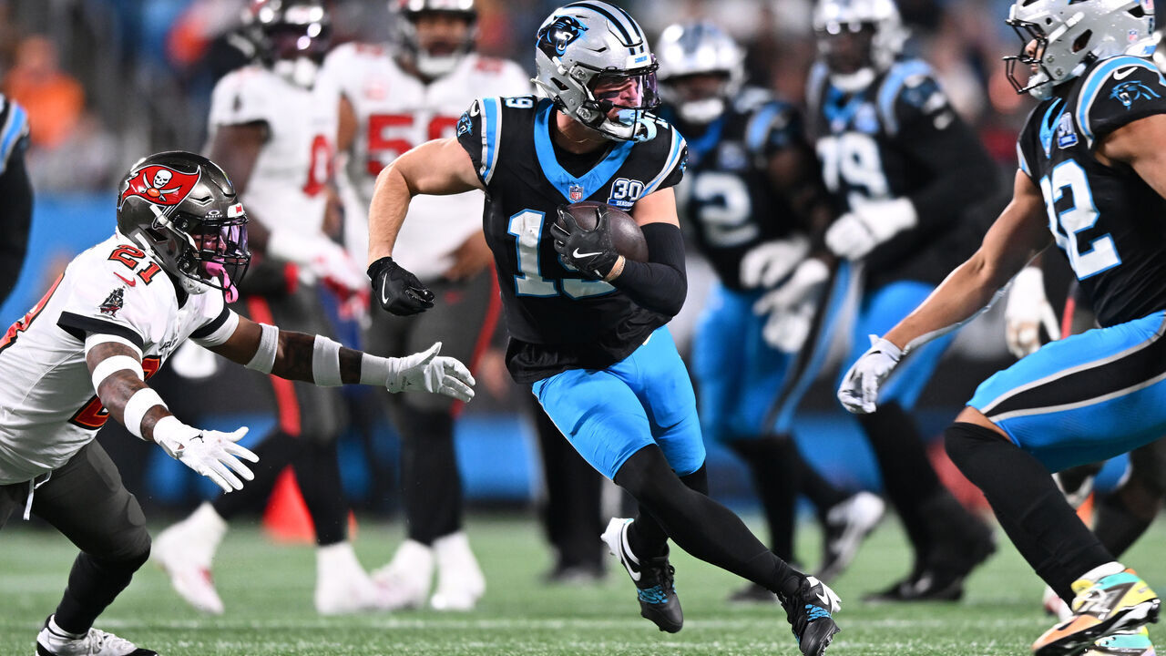 CHARLOTTE, NORTH CAROLINA - DECEMBER 01: Adam Thielen #19 of the Carolina Panthers runs after a catch against Mike Edwards #21 of the Tampa Bay Buccaneers during the second quarter at Bank of America Stadium on December 01, 2024 in Charlotte, North Carolina.