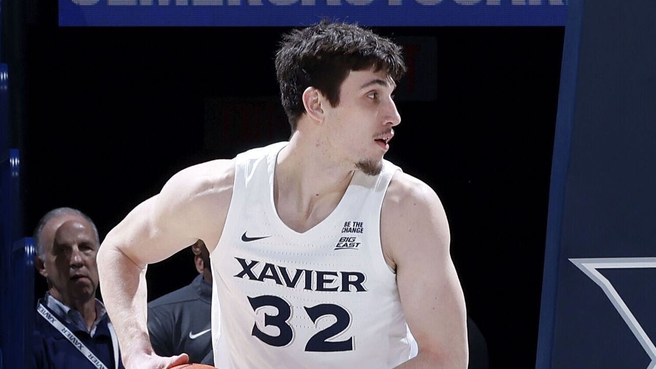 CINCINNATI, OH - NOVEMBER 20: Xavier Musketeers forward Zach Freemantle (32) controls a rebound during a college basketball game against the Siena Saints on November 20, 2024 at Cintas Center in Cincinnati, Ohio.