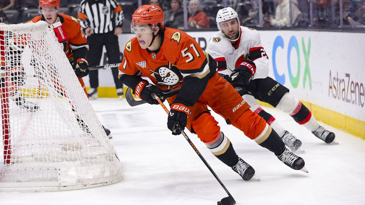 ANAHEIM, CALIFORNIA - DECEMBER 1: Olen Zellweger #51 of the Anaheim Ducks skates past Michael Amadio #22 of the Ottawa Senators during the third period of a game at Honda Center on December 1, 2024 in Anaheim, California.