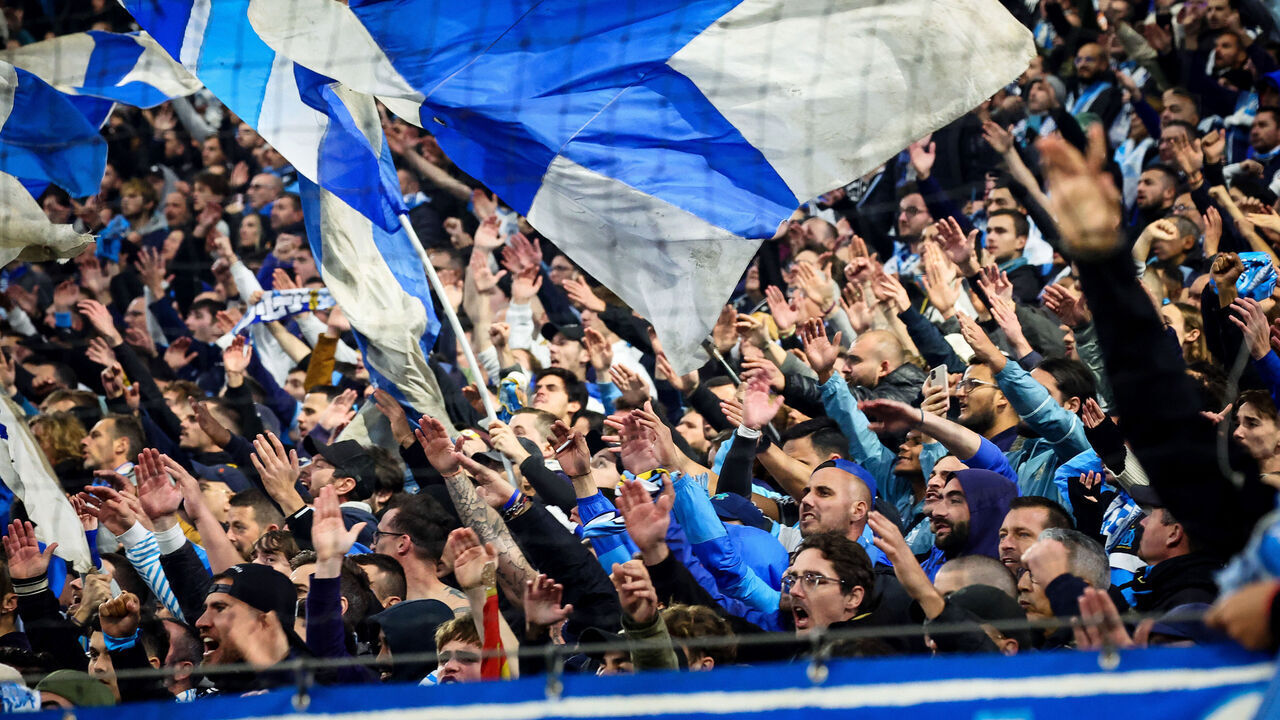 Marseille's supporters wave hands as they attend the French L1 football match between Olympique de Marseille (OM) and AS Monaco at the Stade Velodrome in Marseille, southern France on December 1, 2024.