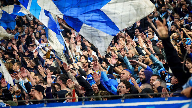 Marseille's supporters wave hands as they attend the French L1 football match between Olympique de Marseille (OM) and AS Monaco at the Stade Velodrome in Marseille, southern France on December 1, 2024.
