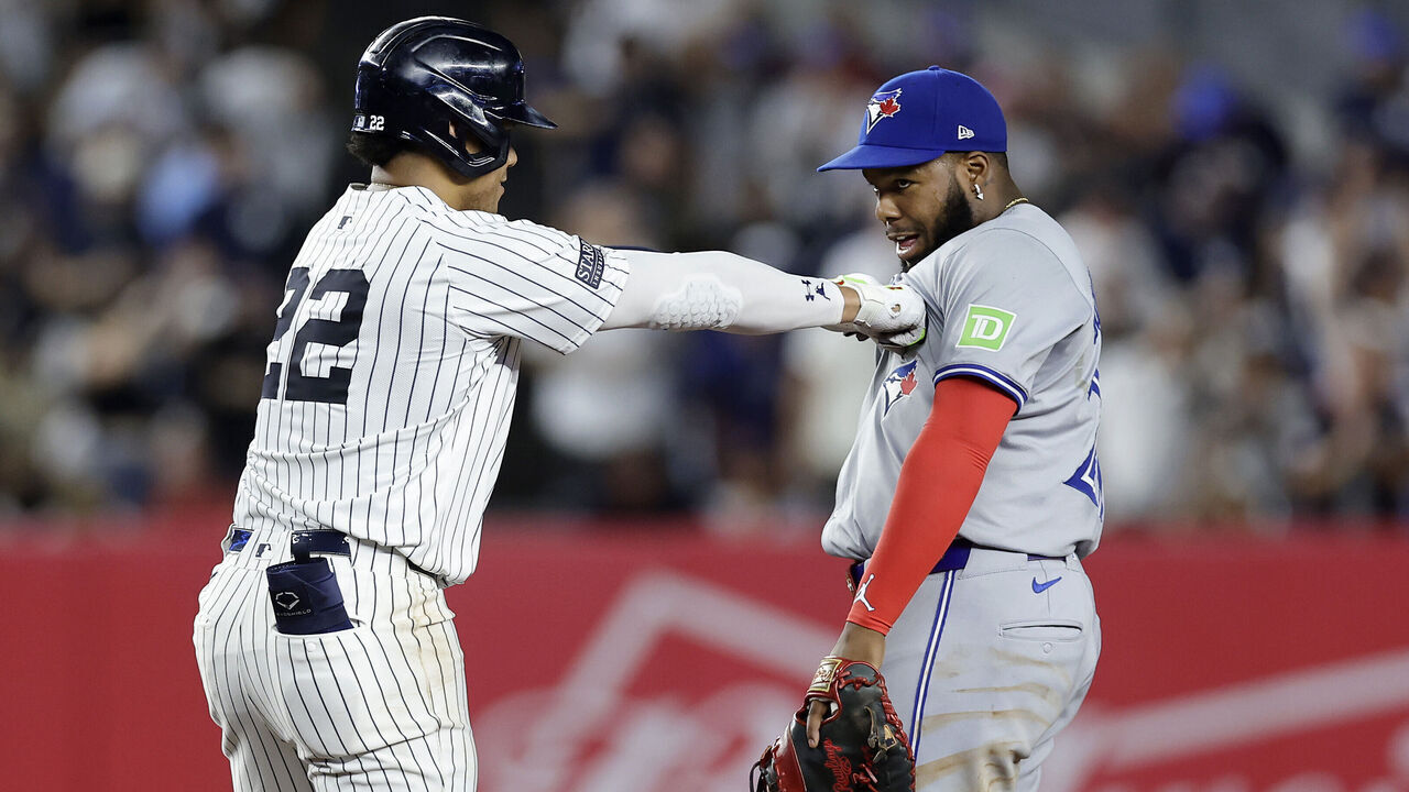 NEW YORK, NEW YORK - AUGUST 02: Juan Soto #22 of the New York Yankees jokes with Vladimir Guerrero Jr. #27 of the Toronto Blue Jays at second base after his double during the first inning at Yankee Stadium on August 02, 2024 in the Bronx borough of New York City.