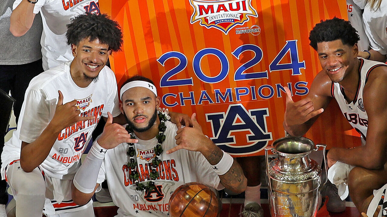 MAUI, HI - NOVEMBER 27: Auburn Tigers forward Johni Broome (4 ) poses with the MVP Trophy and the Wayne Duke Trophy after defeating the Memphis Tigers in the championship game of the Maui Invitational on November 27, 2024, at the Lahaina Civic Center in Maui, Hawaii.