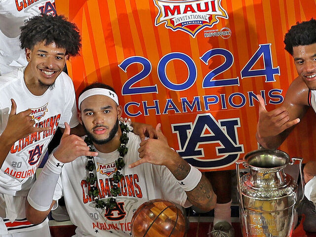 MAUI, HI - NOVEMBER 27: Auburn Tigers forward Johni Broome (4 ) poses with the MVP Trophy and the Wayne Duke Trophy after defeating the Memphis Tigers in the championship game of the Maui Invitational on November 27, 2024, at the Lahaina Civic Center in Maui, Hawaii.