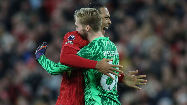 LIVERPOOL, ENGLAND - DECEMBER 01: Virgil van Dijk of Liverpool embraces teammate Caoimhin Kelleher following the team's victory during the Premier League match between Liverpool FC and Manchester City FC at Anfield on December 01, 2024 in Liverpool, England.