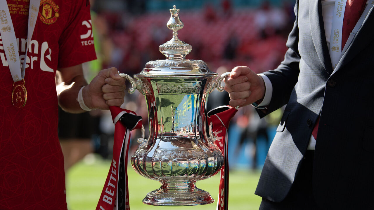 LONDON, ENGLAND - MAY 25: Manchester United manager Eric Ten Hag (left) and Bruno Fernandes hold the Emirates FA Cup trophy as they celebrate winning the Emirates FA Cup Final match between Manchester City and Manchester United at Wembley Stadium on May 25, 2024 in London, England.