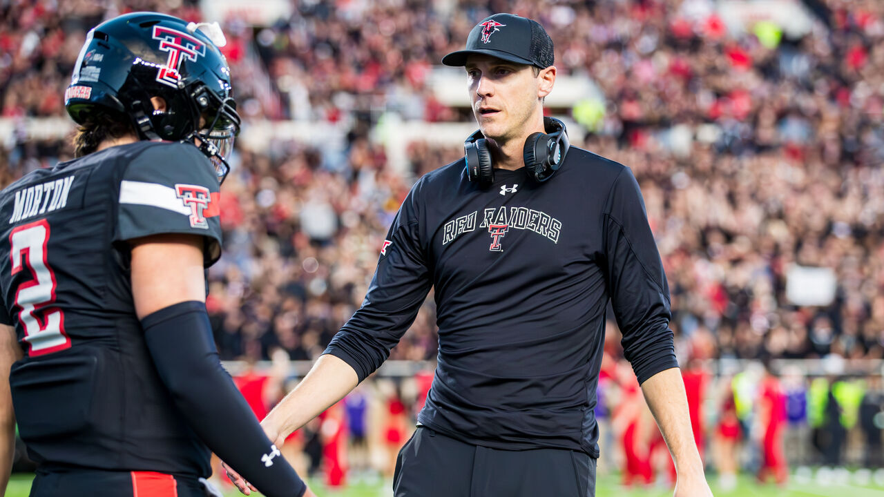 LUBBOCK, TEXAS - OCTOBER 14: Zach Kittley of the Texas Tech Red Raiders talks to Behren Morton #2 during the first half of the game against the Kansas State Wildcats at Jones AT&T Stadium on October 14, 2023 in Lubbock, Texas.