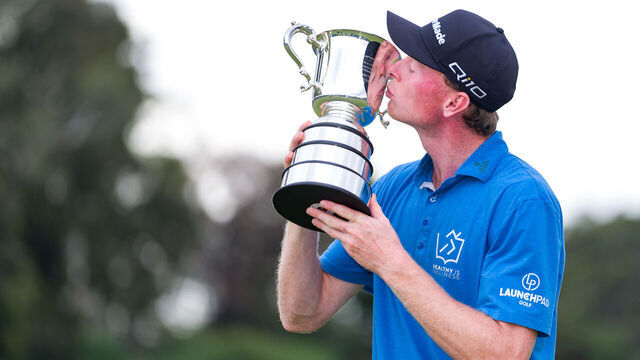 MELBOURNE, AUSTRALIA - DECEMBER 01: Ryggs Johnston of the United States kisses the Stonehaven Cup on day four of the ISPS Handa Australian Open 2024 at Kingston Heath Golf Club on December 01, 2024 in Melbourne, Australia.