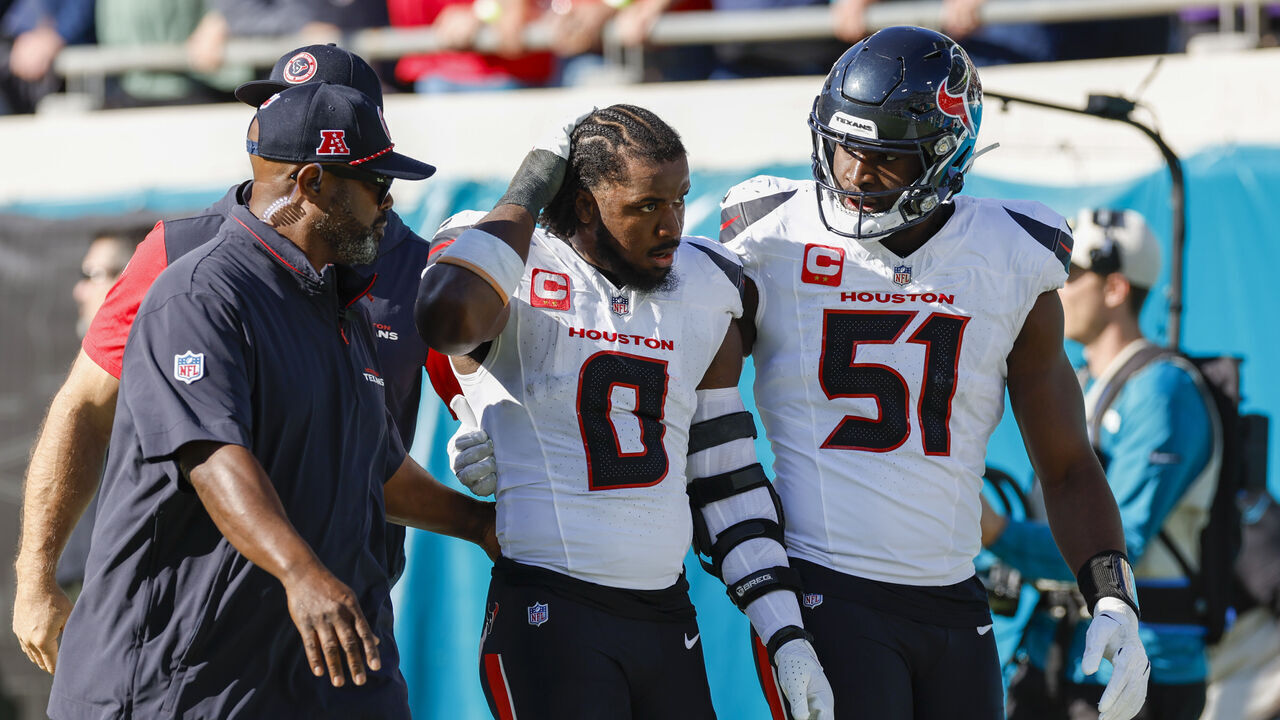 JACKSONVILLE, FL - DECEMBER 01: Houston Texans linebacker Azeez Al-Shaair (0) is escorted off the field by Houston Texans defensive end Will Anderson Jr. (51) after being ejected from the game between the Jacksonville Jaguars and the Houston Texans on December 1, 2024 at EverBank Stadium in Jacksonville, Fl.