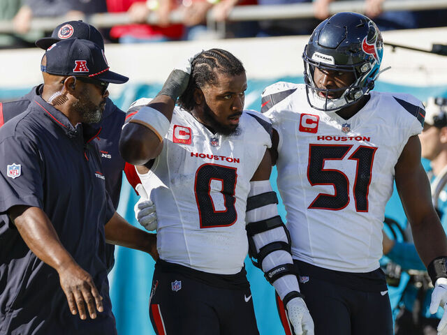 JACKSONVILLE, FL - DECEMBER 01: Houston Texans linebacker Azeez Al-Shaair (0) is escorted off the field by Houston Texans defensive end Will Anderson Jr. (51) after being ejected from the game between the Jacksonville Jaguars and the Houston Texans on December 1, 2024 at EverBank Stadium in Jacksonville, Fl.