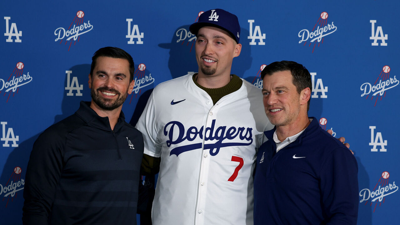 LOS ANGELES, CALIFORNIA - DECEMBER 03: Blake Snell poses for a picture with Dodgers executives Brandon Gomes and Andrew Friedman during a press conference introducing him as a Los Angeles Dodger at Dodger Stadium on December 03, 2024 in Los Angeles, California.