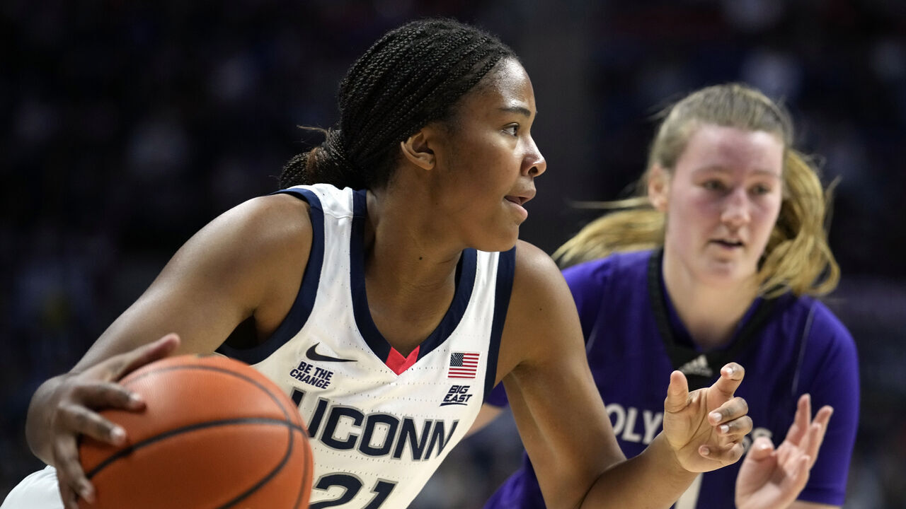 STORRS, CONNECTICUT - DECEMBER 3: Sarah Strong #21 of the Connecticut Huskies is defended by Meg Cahalan #4of the Holy Cross Crusaders during the first half of an NCAA women's basketball game at the Harry A. Gampel Pavilion on December 3, 2024 in Storrs, Connecticut.