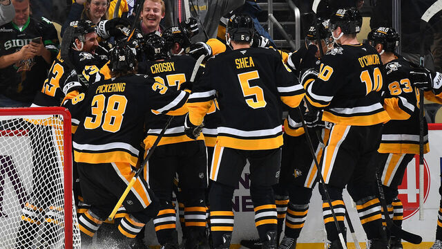 PITTSBURGH, PA - DECEMBER 03: Bryan Rust #17 of the Pittsburgh Penguins celebrate his overtime goal with teammates against the Florida Panthers at PPG PAINTS Arena on December 3, 2024 in Pittsburgh, Pennsylvania.
