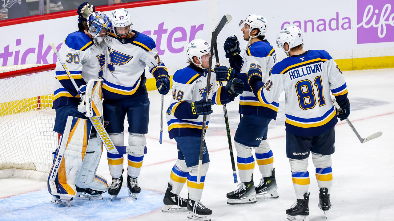 WINNIPEG, CANADA - DECEMBER 3: St. Louis Blues players celebrate on the ice following a 4-1 victory over the Winnipeg Jets at the Canada Life Centre on December 3, 2024 in Winnipeg, Manitoba, Canada.