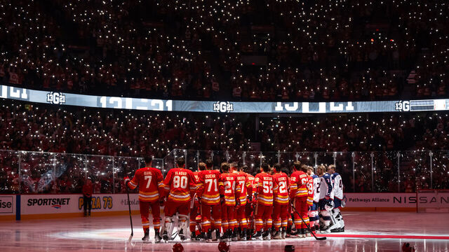 CALGARY, AB - DECEMBER 03: The Calgary Flames and Columbus Blue Jackets pay tribute to the late Johnny Gaudreau before an NHL game on December 3, 2024, at the Scotiabank Saddledome in Calgary, AB.