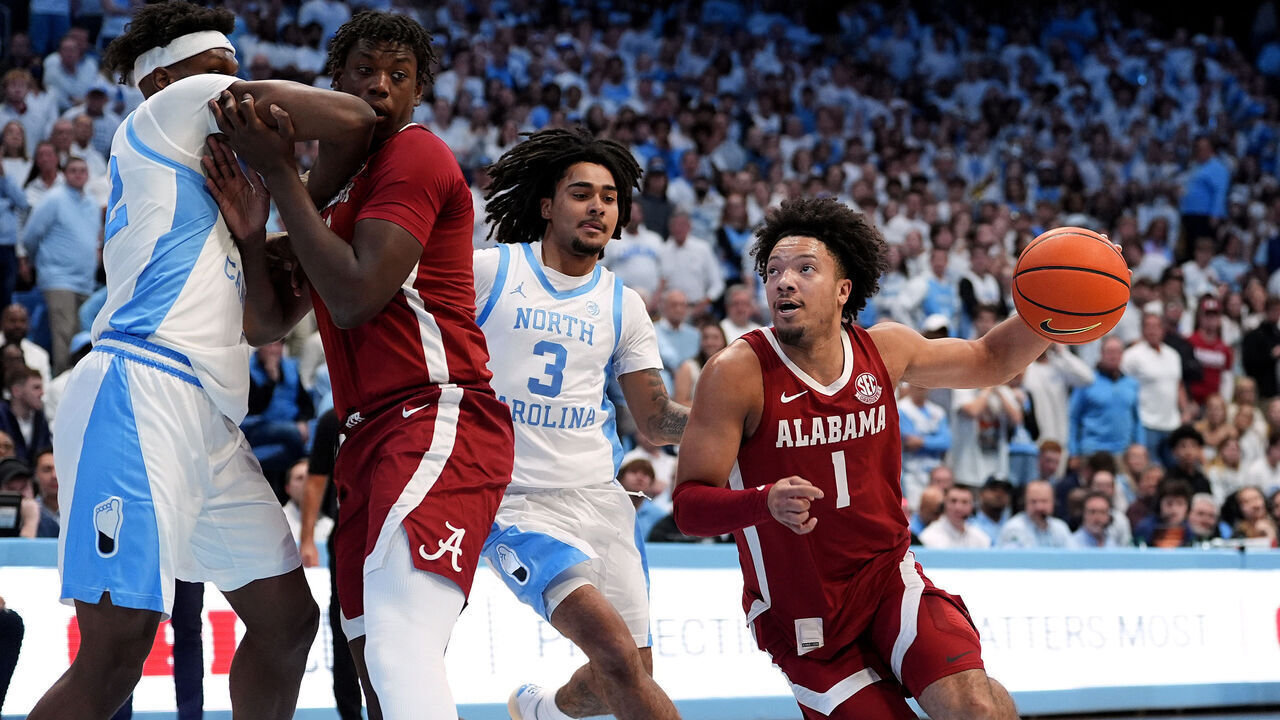 CHAPEL HILL, NORTH CAROLINA - DECEMBER 04: Mark Sears #1 of the Alabama Crimson Tide drives to the basket against Elliot Cadeau #3 of the North Carolina Tar Heels during the first half of the game at the Dean E. Smith Center on December 04, 2024 in Chapel Hill, North Carolina.