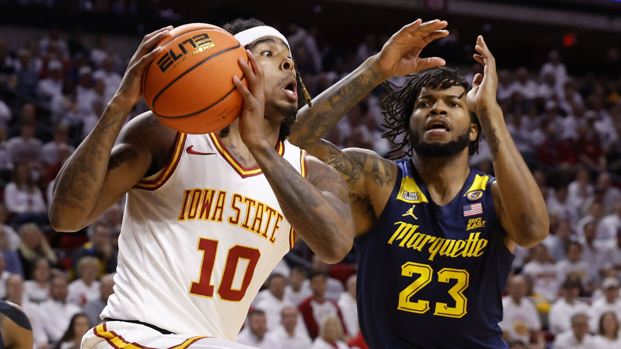 AMES, IA - DECEMBER 4: Keshon Gilbert #10 of the Iowa State Cyclones takes a shot as David Joplin #23 of the Marquette Golden Eagles defends in the first half of play at Hilton Coliseum on December 4, 2024 in Ames, Iowa.