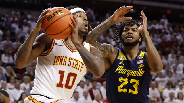 AMES, IA - DECEMBER 4: Keshon Gilbert #10 of the Iowa State Cyclones takes a shot as David Joplin #23 of the Marquette Golden Eagles defends in the first half of play at Hilton Coliseum on December 4, 2024 in Ames, Iowa.