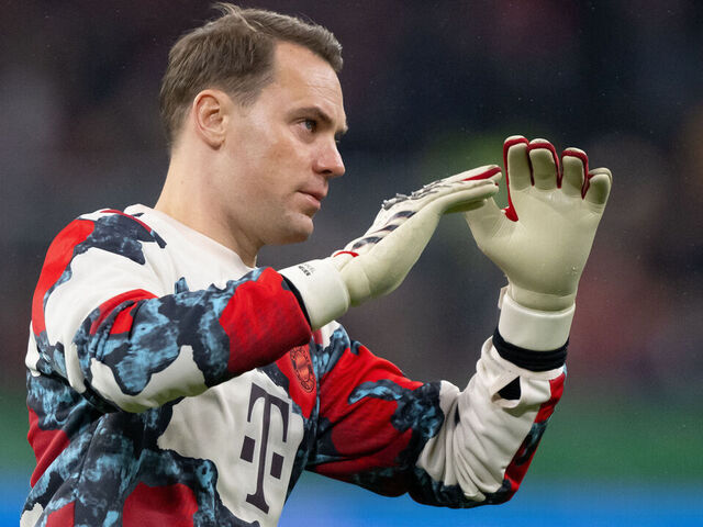 03 December 2024, Bavaria, Munich: Soccer: DFB Cup, Bayern Munich - Bayer Leverkusen, round of 16 at the Allianz Arena. A cameraman stands in the stadium before the game. Goalkeeper Manuel Neuer from Munich is warming up. Photo: Sven Hoppe/dpa - IMPORTANT NOTE: In accordance with the regulations of the DFL German Football League and the DFB German Football Association, it is prohibited to utilize or have utilized photographs taken in the stadium and/or of the match in the form of sequential images and/or video-like photo series.
