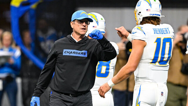 ATLANTA, GA DECEMBER 01: Los Angeles head coach Jim Harbaugh gives quarterback Justin Herbert (10) a first bump prior to the start of the NFL game between the Los Angeles Chargers and the Atlanta Falcons on December 1st, 2024 at Mercedes-Benz Stadium in Atlanta, GA.