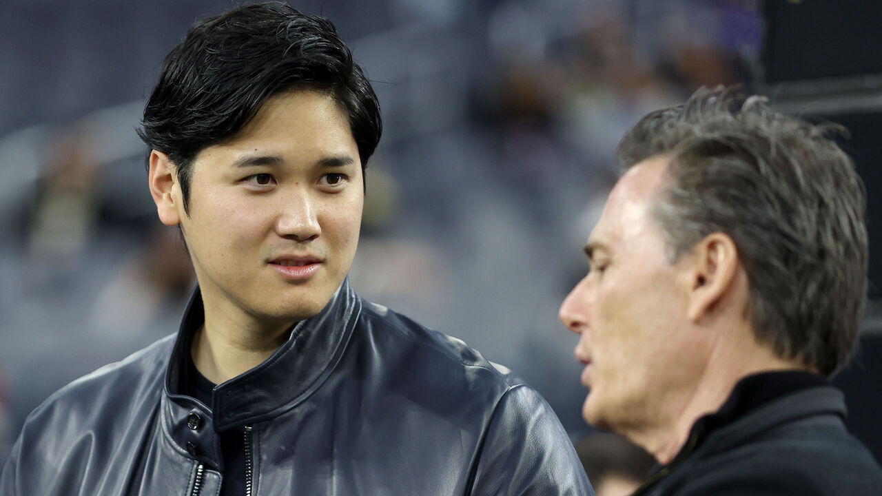 INGLEWOOD, CALIFORNIA - DECEMBER 21: (L-R) Shohei Ohtani of the Los Angeles Dodgers talks with agent Nez Balelo prior to the game between the New Orleans Saints and the Los Angeles Rams at SoFi Stadium on December 21, 2023 in Inglewood, California.