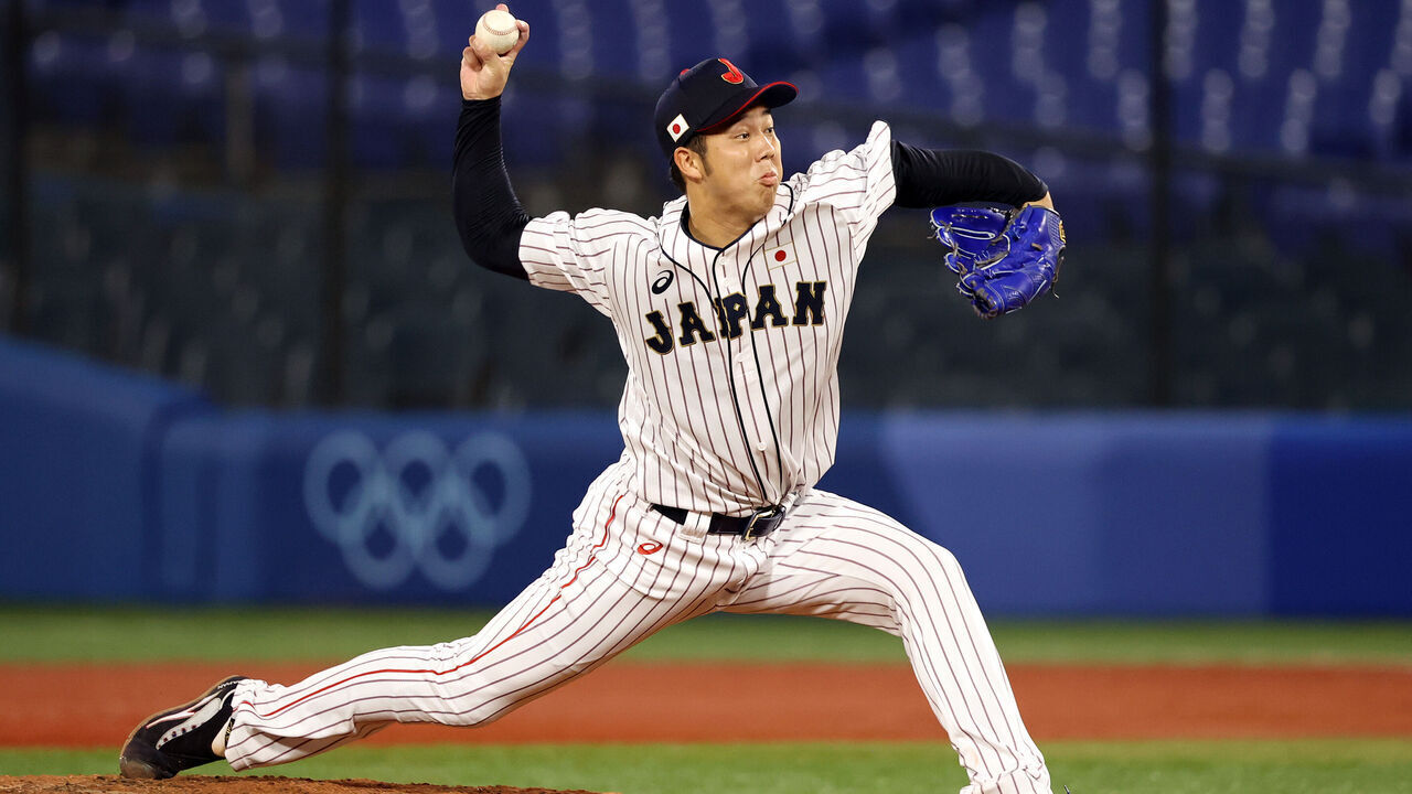 YOKOHAMA, JAPAN - AUGUST 02: Koyo Aoyagi #12 of Team Japan pitches in the fifth inning against Team United States during the knockout stage of men's baseball on day ten of the Tokyo 2020 Olympic Games at Yokohama Baseball Stadium on August 02, 2021 in Yokohama, Kanagawa, Japan.