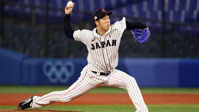 YOKOHAMA, JAPAN - AUGUST 02: Koyo Aoyagi #12 of Team Japan pitches in the fifth inning against Team United States during the knockout stage of men's baseball on day ten of the Tokyo 2020 Olympic Games at Yokohama Baseball Stadium on August 02, 2021 in Yokohama, Kanagawa, Japan.