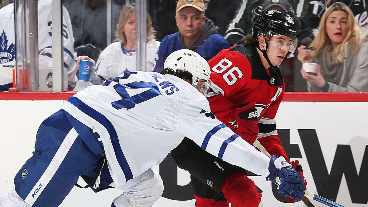 NEWARK, NJ - FEBRUARY 1: Jack Hughes #86 of the New Jersey Devils and Auston Matthews #34 of the Toronto Maple Leafs battle for position at Prudential Center on February 1, 2022 in Newark, New Jersey.