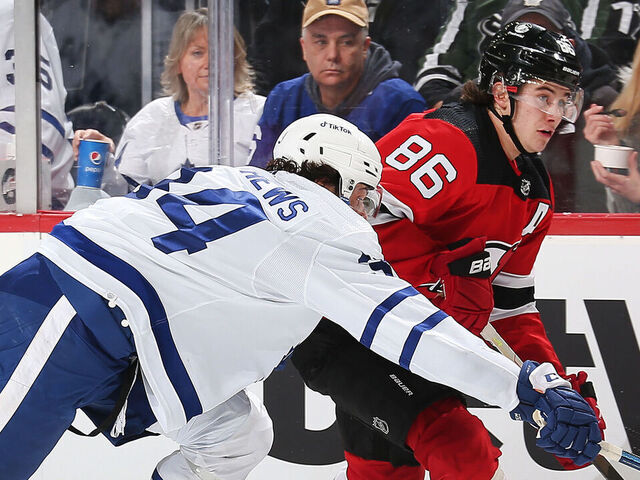 NEWARK, NJ - FEBRUARY 1: Jack Hughes #86 of the New Jersey Devils and Auston Matthews #34 of the Toronto Maple Leafs battle for position at Prudential Center on February 1, 2022 in Newark, New Jersey.