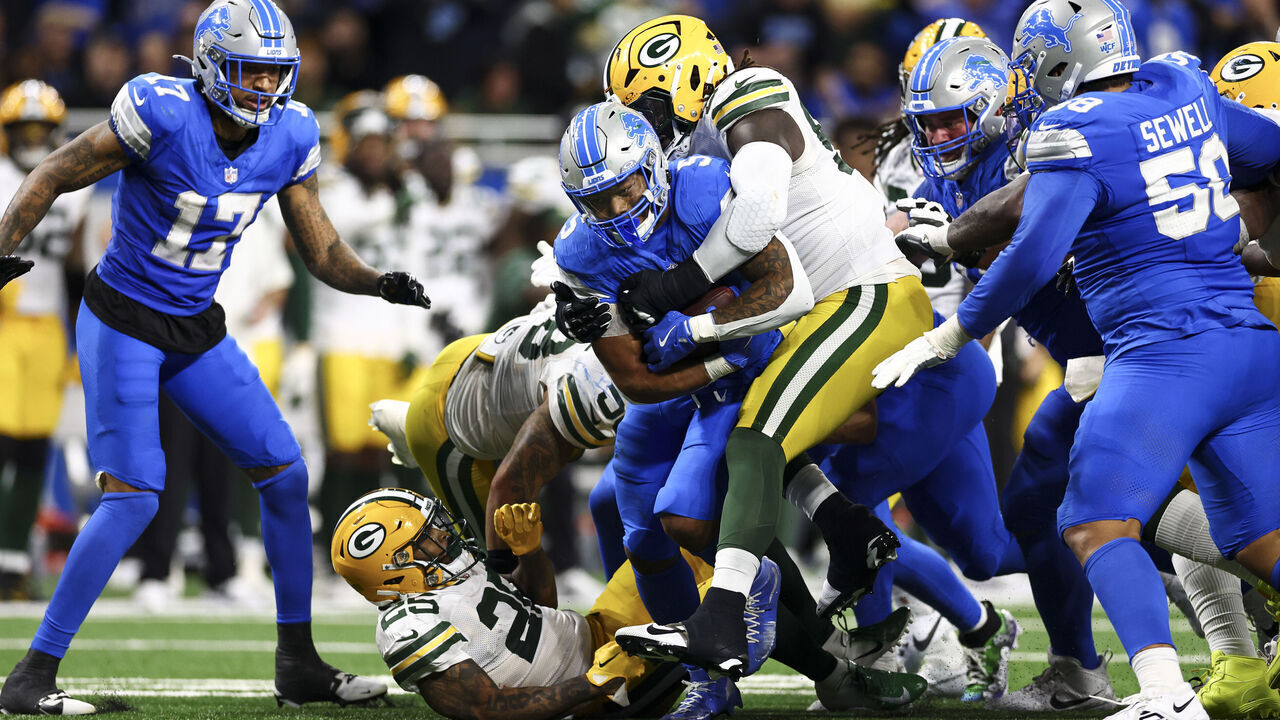 DETROIT, MICHIGAN - DECEMBER 05: David Montgomery #5 of the Detroit Lions carries the ball for a first down on fourth and one during the second half of an NFL football game against the Green Bay Packers at Ford Field on December 5, 2024 in Detroit, Michigan.