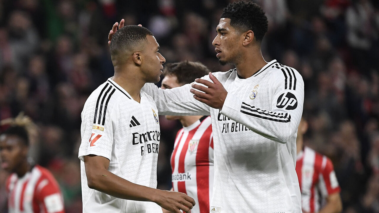 TOPSHOT - Real Madrid's French forward #09 Kylian Mbappe is comforted by Real Madrid's English midfielder #05 Jude Bellingham after failing to score from the penalty spot during the Spanish league football match between Athletic Club Bilbao and Real Madrid CF at the San Mames stadium in Bilbao on December 4, 2024.