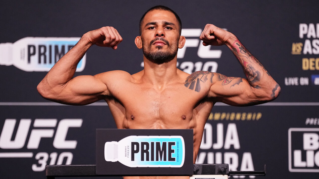 LAS VEGAS, NEVADA - DECEMBER 06: Alexandre Pantoja of Brazil poses on the scale during the UFC 310 official weigh-in at UFC APEX on December 06, 2024 in Las Vegas, Nevada.