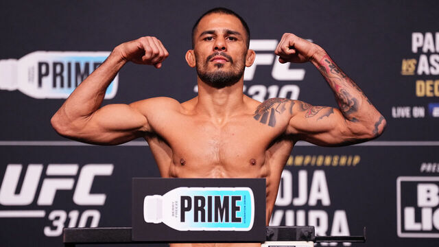 LAS VEGAS, NEVADA - DECEMBER 06: Alexandre Pantoja of Brazil poses on the scale during the UFC 310 official weigh-in at UFC APEX on December 06, 2024 in Las Vegas, Nevada.