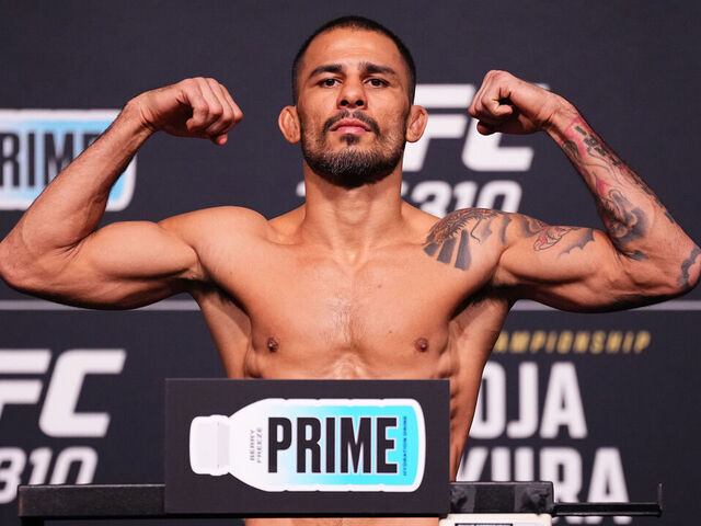 LAS VEGAS, NEVADA - DECEMBER 06: Alexandre Pantoja of Brazil poses on the scale during the UFC 310 official weigh-in at UFC APEX on December 06, 2024 in Las Vegas, Nevada.