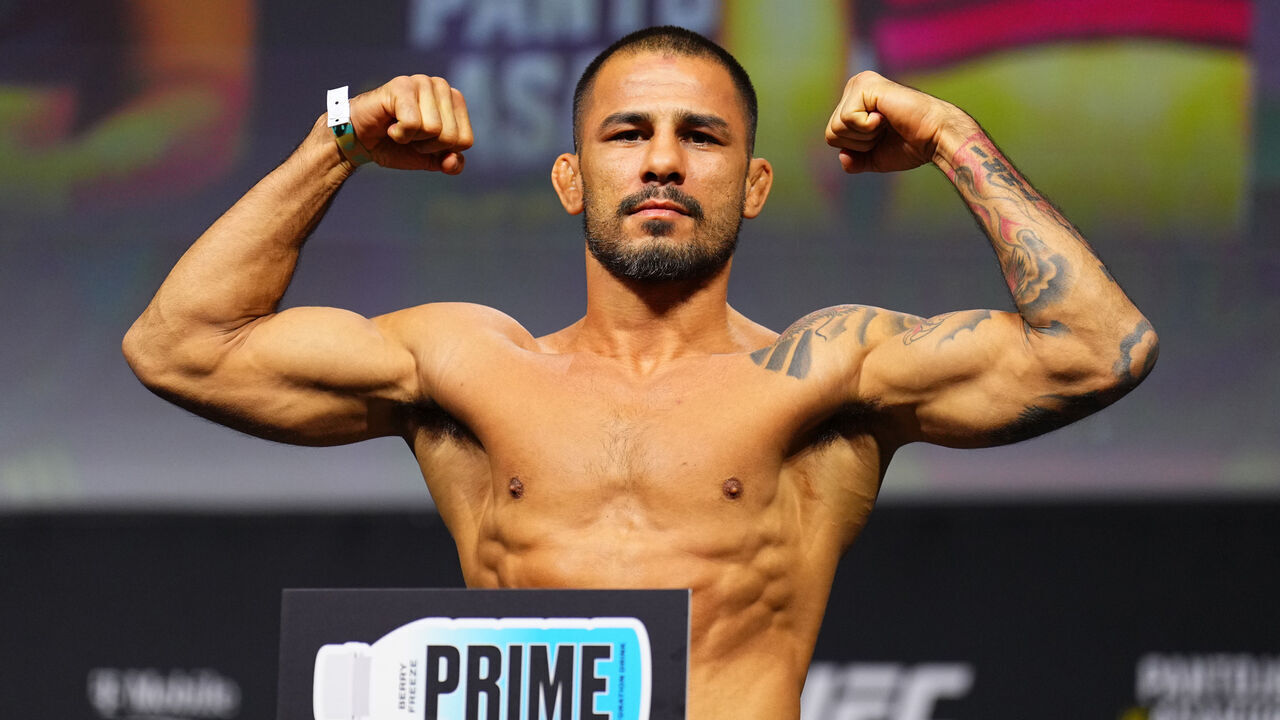LAS VEGAS, NEVADA - DECEMBER 06: Alexandre Pantoja of Brazil poses on the scale during the UFC 310 ceremonial weigh-in at MGM Grand Garden Arena on December 06, 2024 in Las Vegas, Nevada.